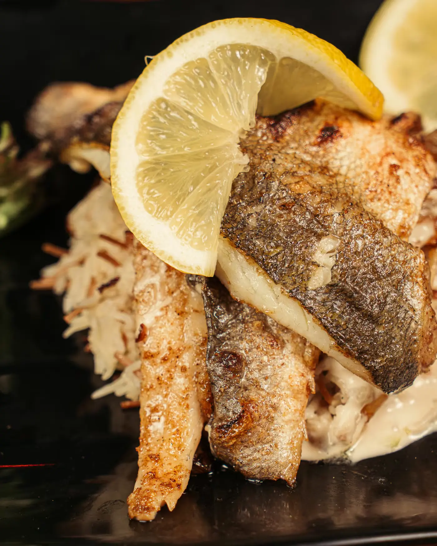Close-up of grilled sea bass over rice with lemon at Beirut Restaurant, food photography by Gorka Di Capitan (gorkadicapitan.com)