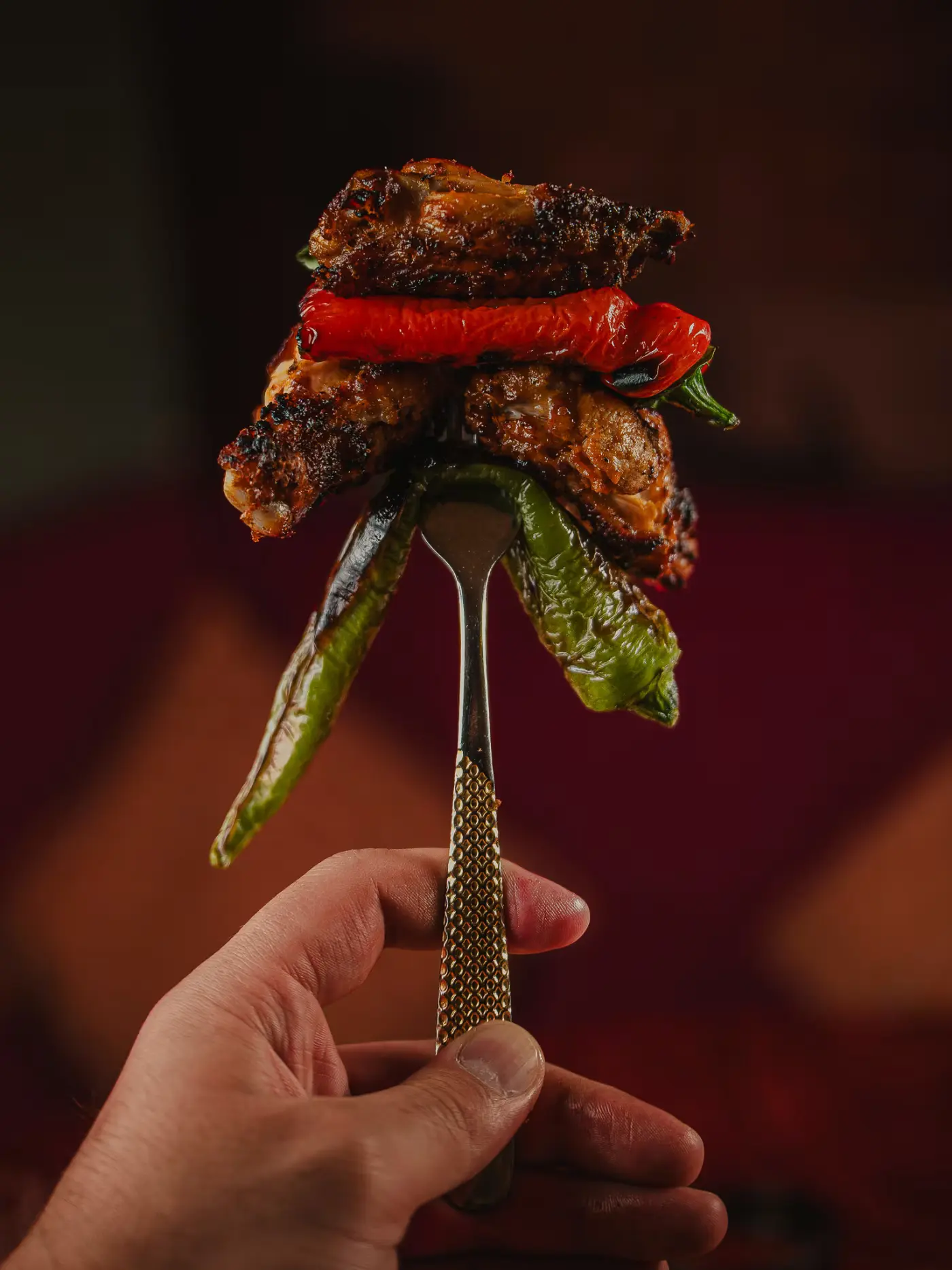 Grilled meat and a charred pepper raised on a fork at Beirut Restaurant, captured by Gorka Di Capitan (gorkadicapitan.com), food photography