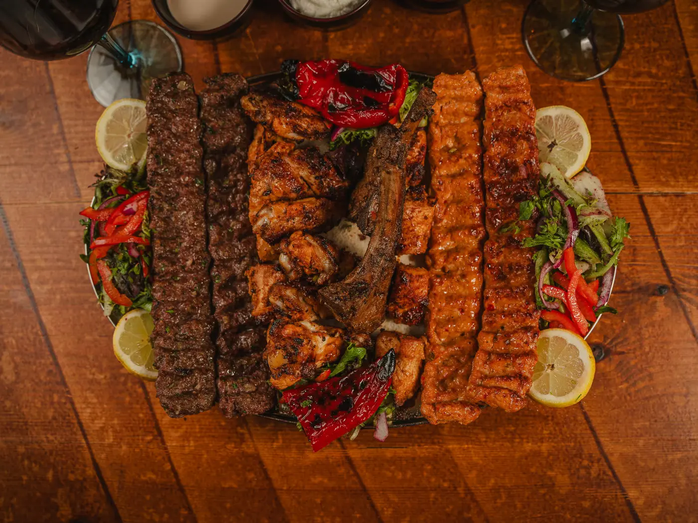 Overhead view of the mixed grill platter with lemon and charred peppers at Beirut Restaurant, food photography session by Gorka Di Capitan (gorkadicapitan.com)