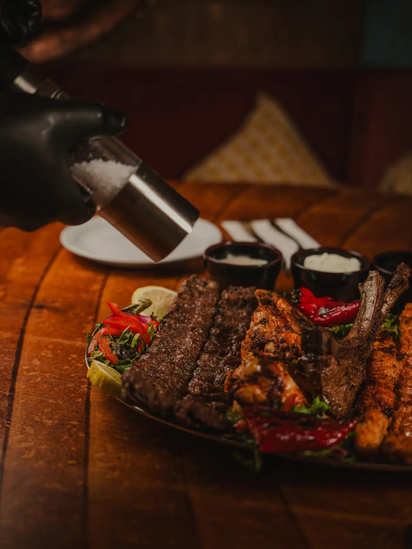 Seasoning sprinkled over the mixed grill platter at Beirut Restaurant, food photography by Gorka Di Capitan (gorkadicapitan.com)