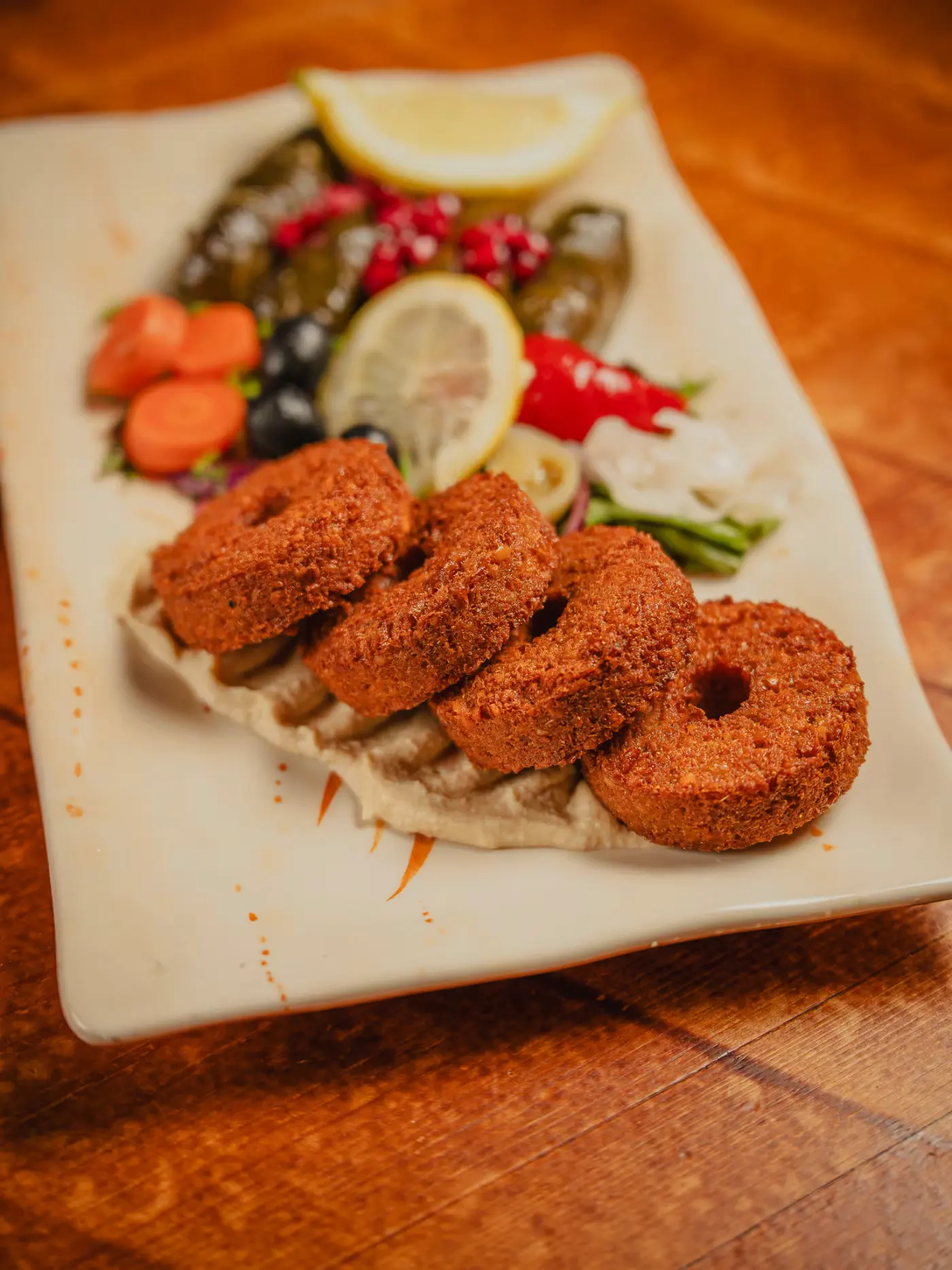 Falafel served with vine leaves, pickles and salad at Beirut Restaurant, food photography by Gorka Di Capitan (gorkadicapitan.com)