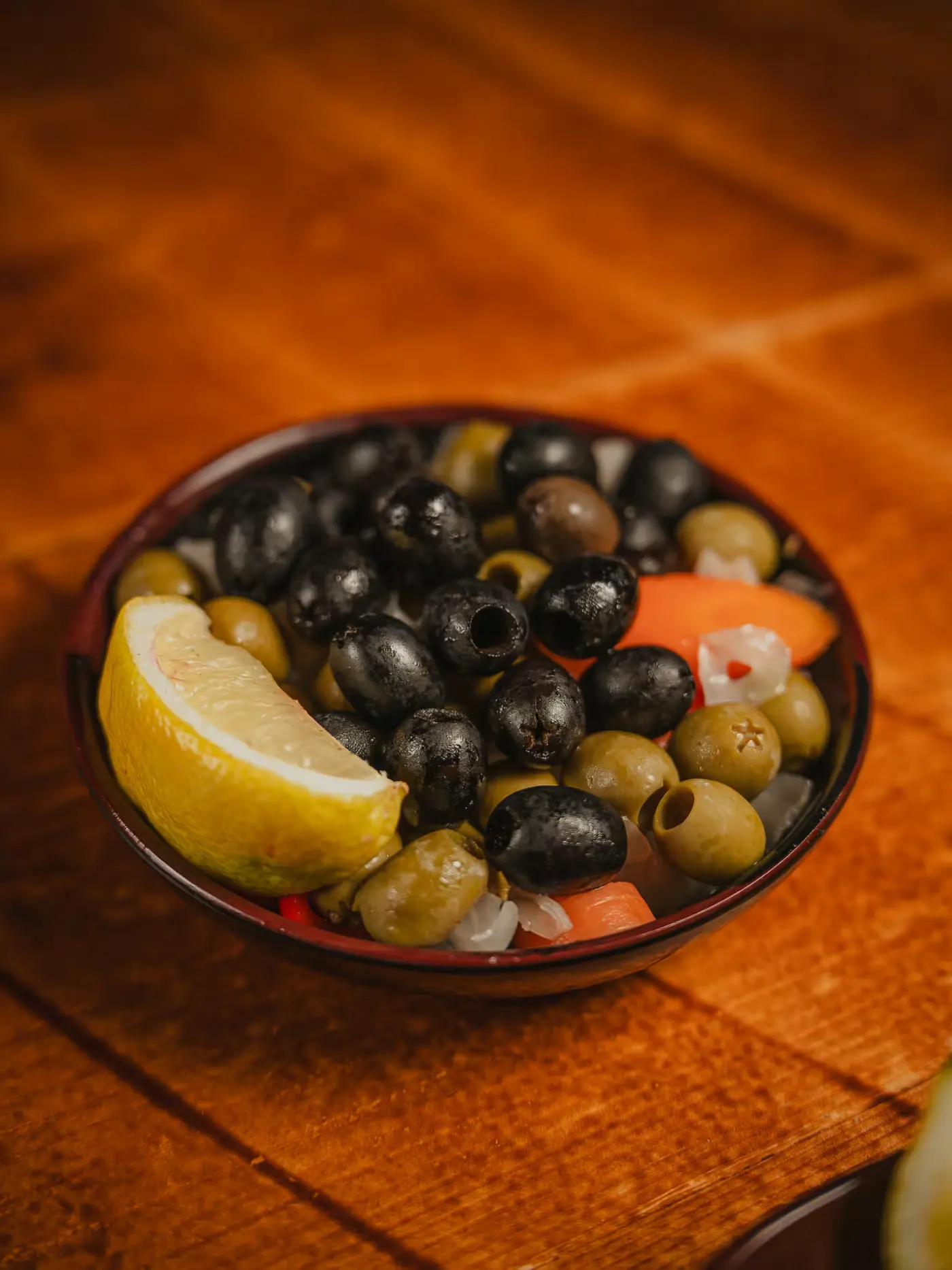 Bowl of marinated black and green olives with lemon at Beirut Restaurant. Photographed by Gorka Di Capitan (gorkadicapitan.com).