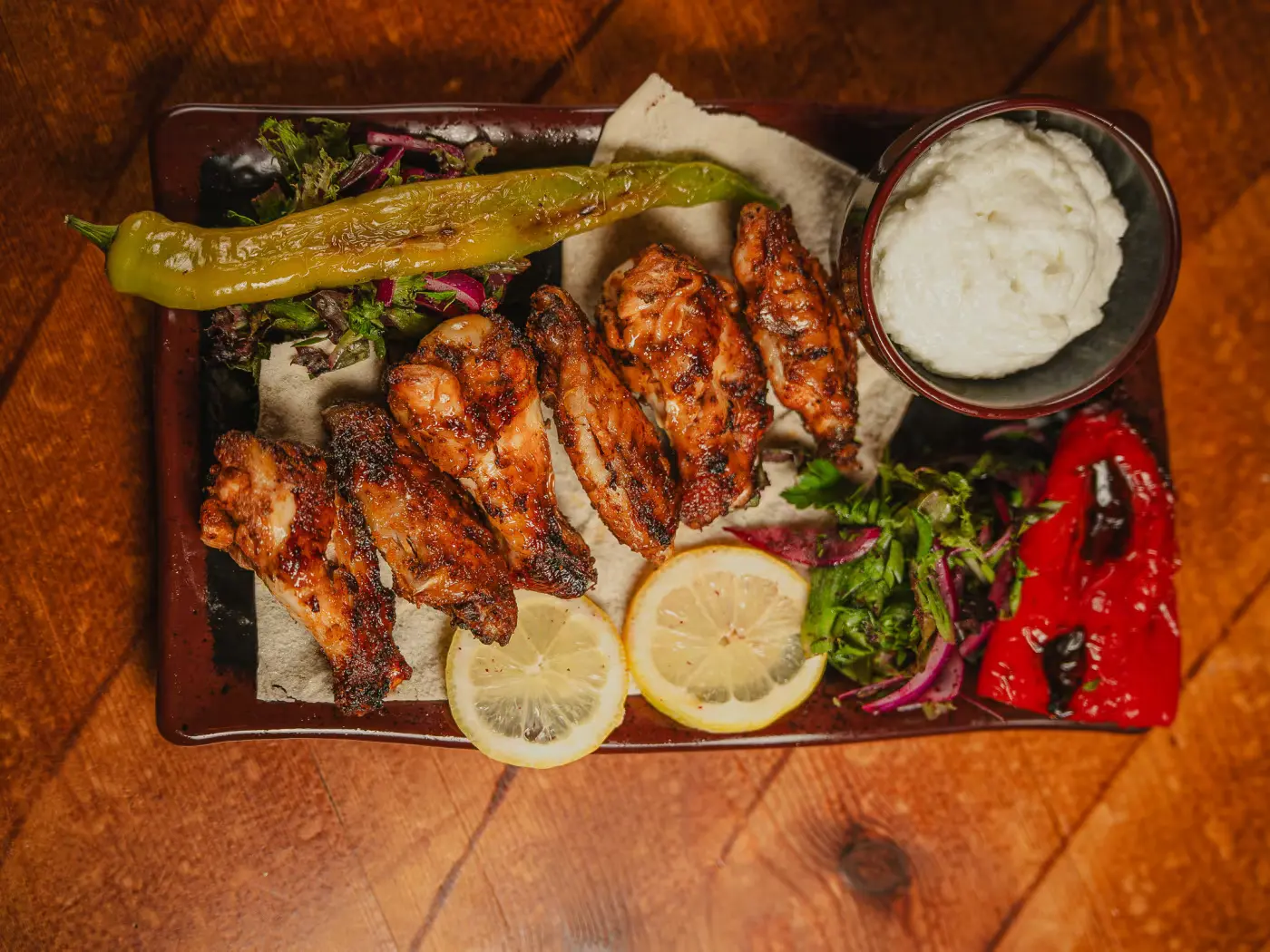 Grilled chicken wings with garlic dip, lemon and charred pepper at Beirut Restaurant, food photography by Gorka Di Capitan (gorkadicapitan.com)