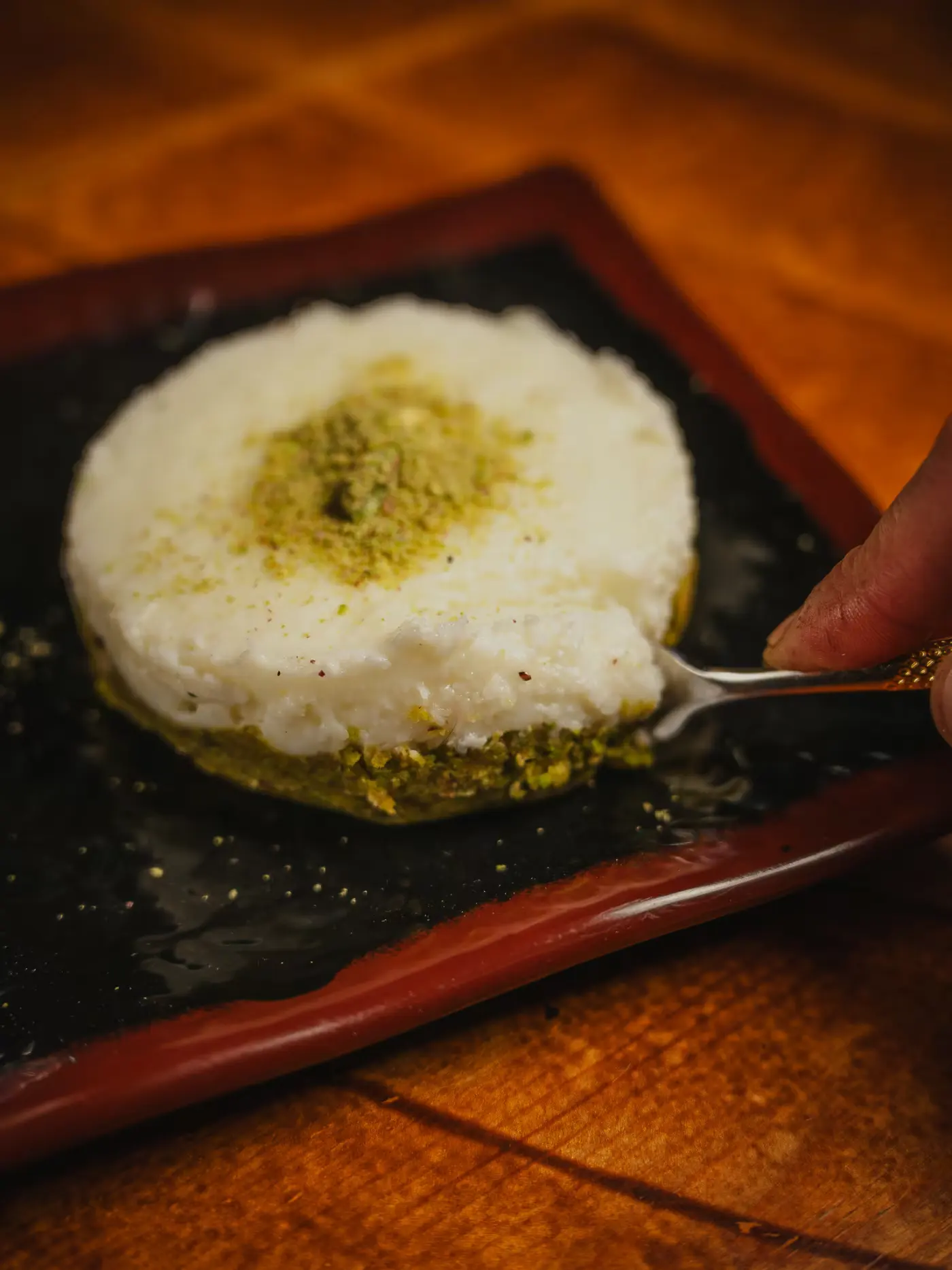 Lebanese milk pudding topped with ground pistachio at Beirut Restaurant, shot by Gorka Di Capitan (gorkadicapitan.com)